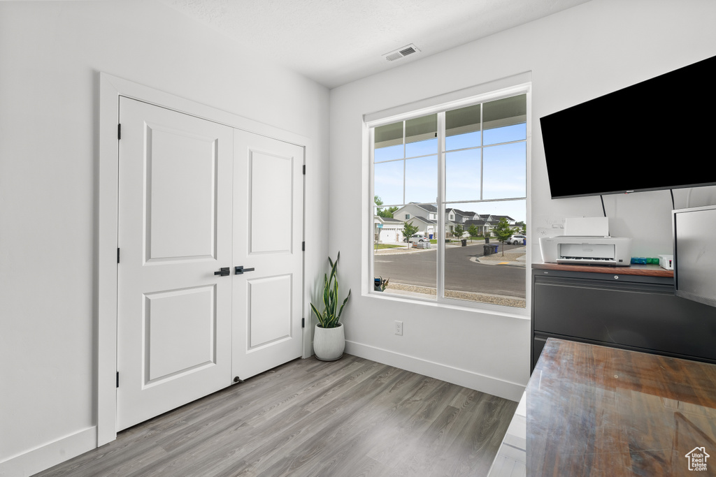 Bedroom featuring wood finished floors and a closet