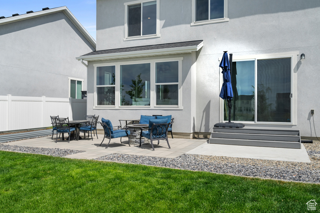 Rear view of property featuring stucco siding and a patio