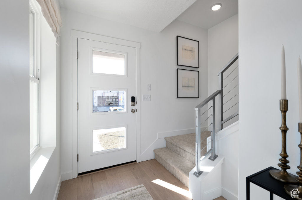Entrance foyer featuring stairway, wood finished floors, and recessed lighting
