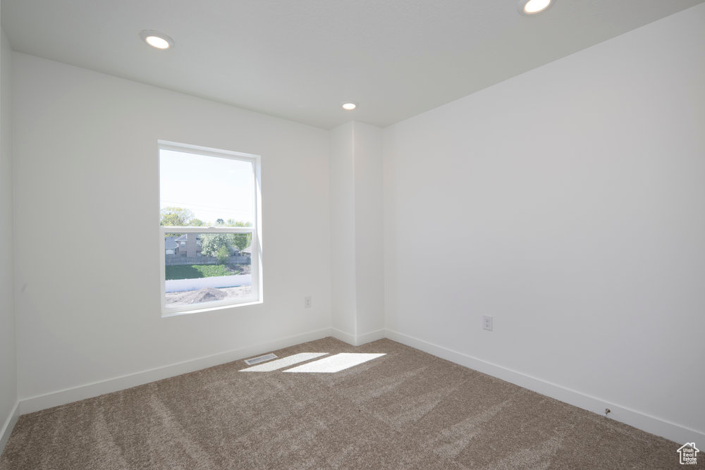 Empty room featuring carpet and recessed lighting