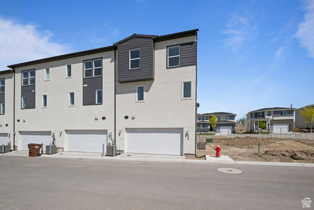 Back of property featuring stucco siding and an attached garage