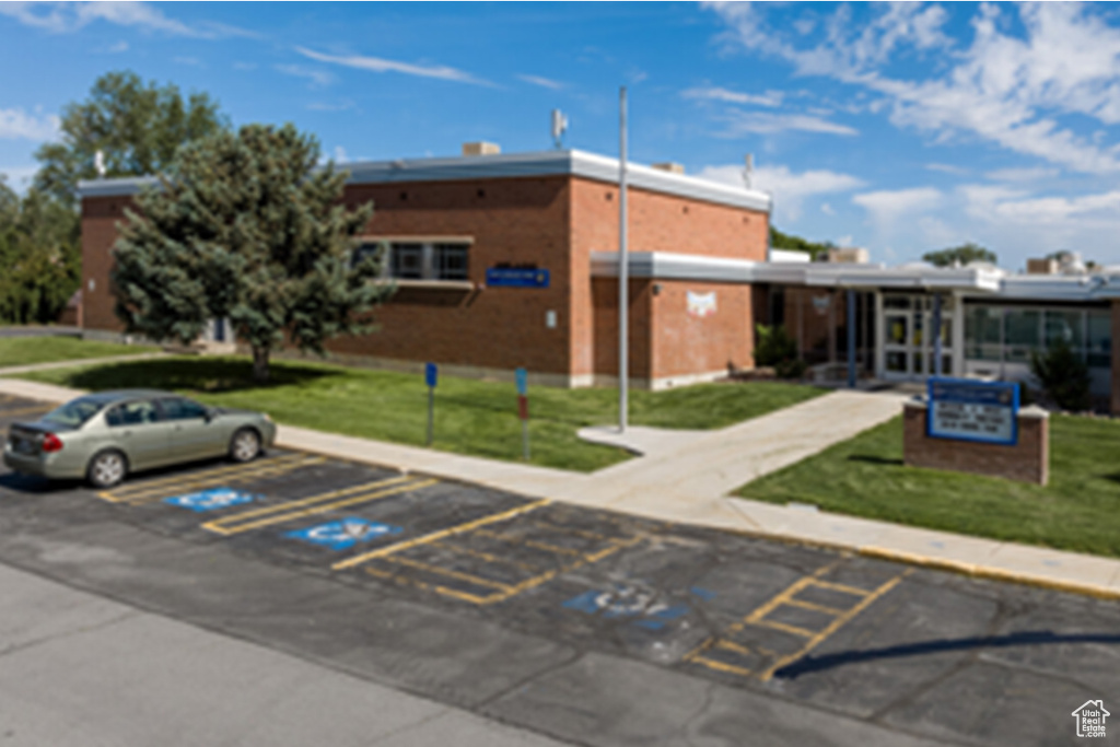 View of building exterior featuring uncovered parking