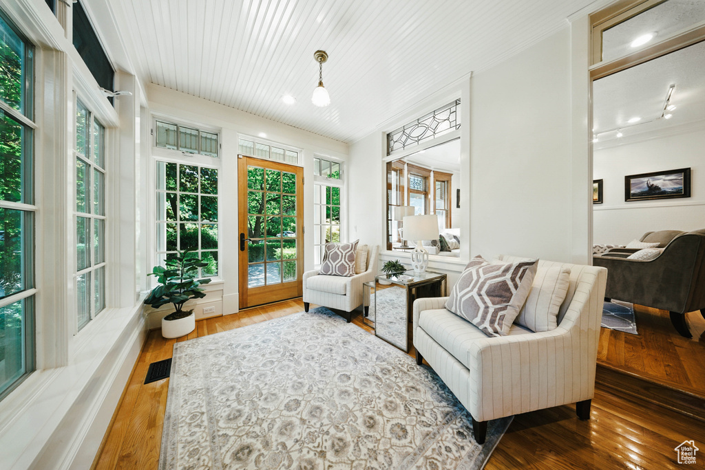Living area with plenty of natural light, wood-type flooring, and recessed lighting