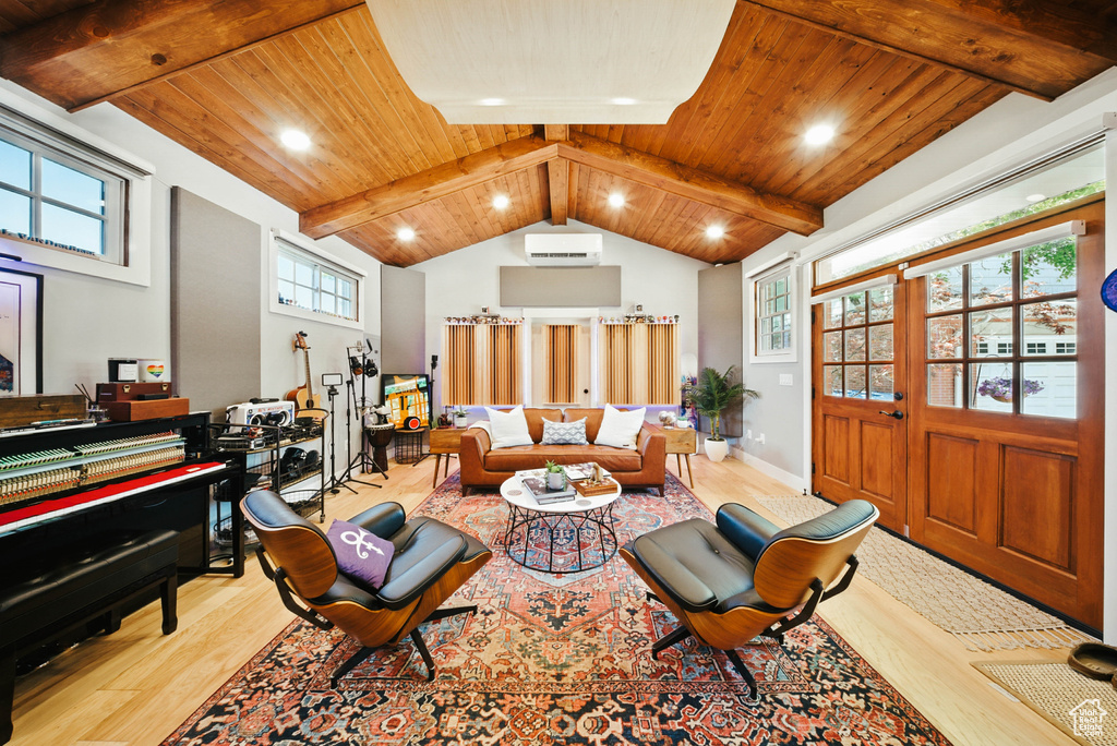 Living area with wood finished floors, a wall unit AC, recessed lighting, and wooden ceiling
