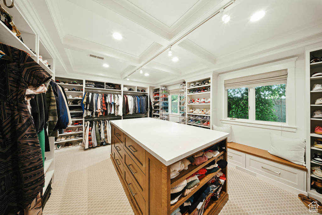 Walk in closet with carpet flooring, coffered ceiling, and beam ceiling