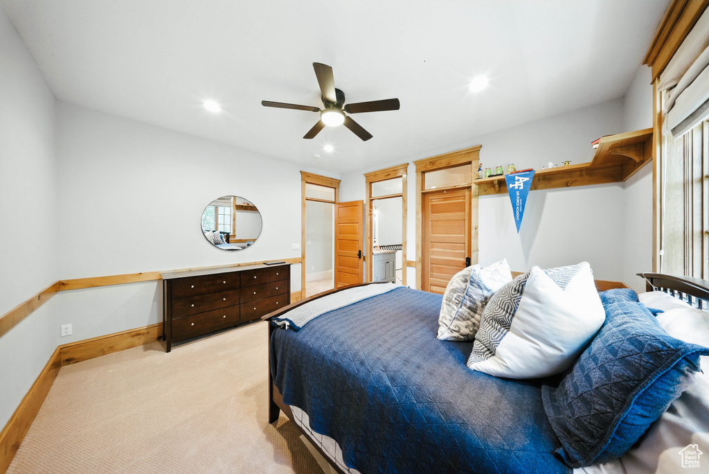 Bedroom with light carpet, ceiling fan, and recessed lighting
