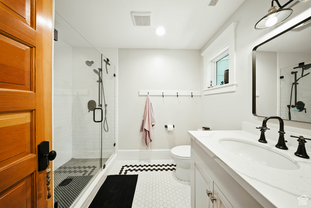 Bathroom with a stall shower and vanity