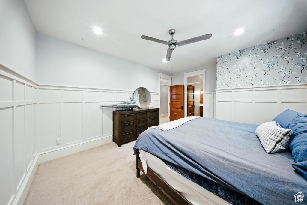 Bedroom featuring a decorative wall, a wainscoted wall, light carpet, recessed lighting, and ceiling fan