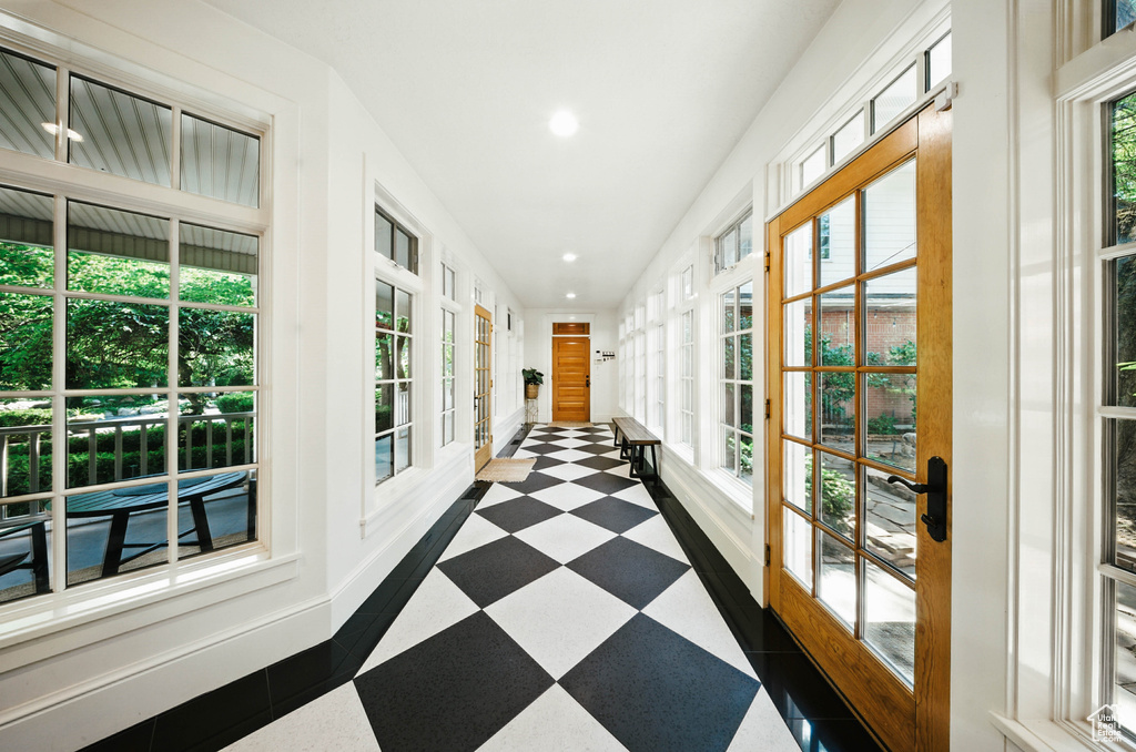 Hallway with tile patterned floors and recessed lighting
