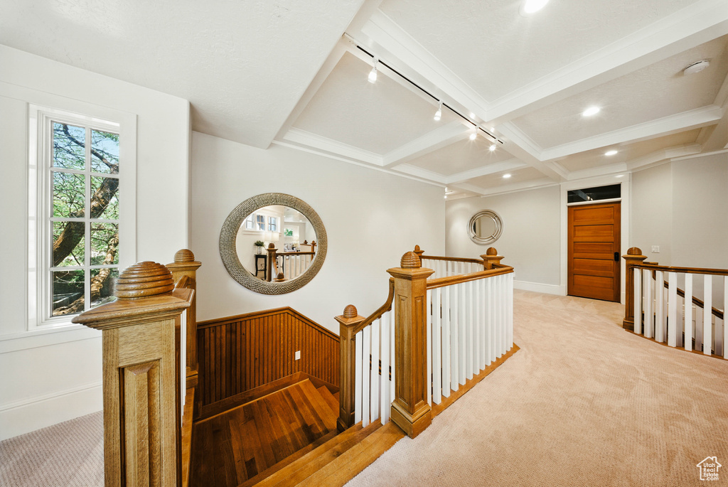 Hall with an upstairs landing, beam ceiling, carpet floors, rail lighting, and recessed lighting