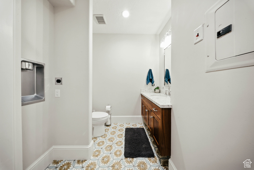 Bathroom featuring vanity, tile patterned flooring, and recessed lighting