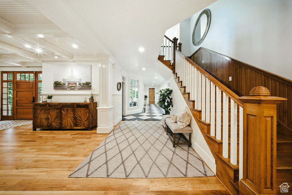 Entrance foyer with wood finished floors, stairway, recessed lighting, and beam ceiling