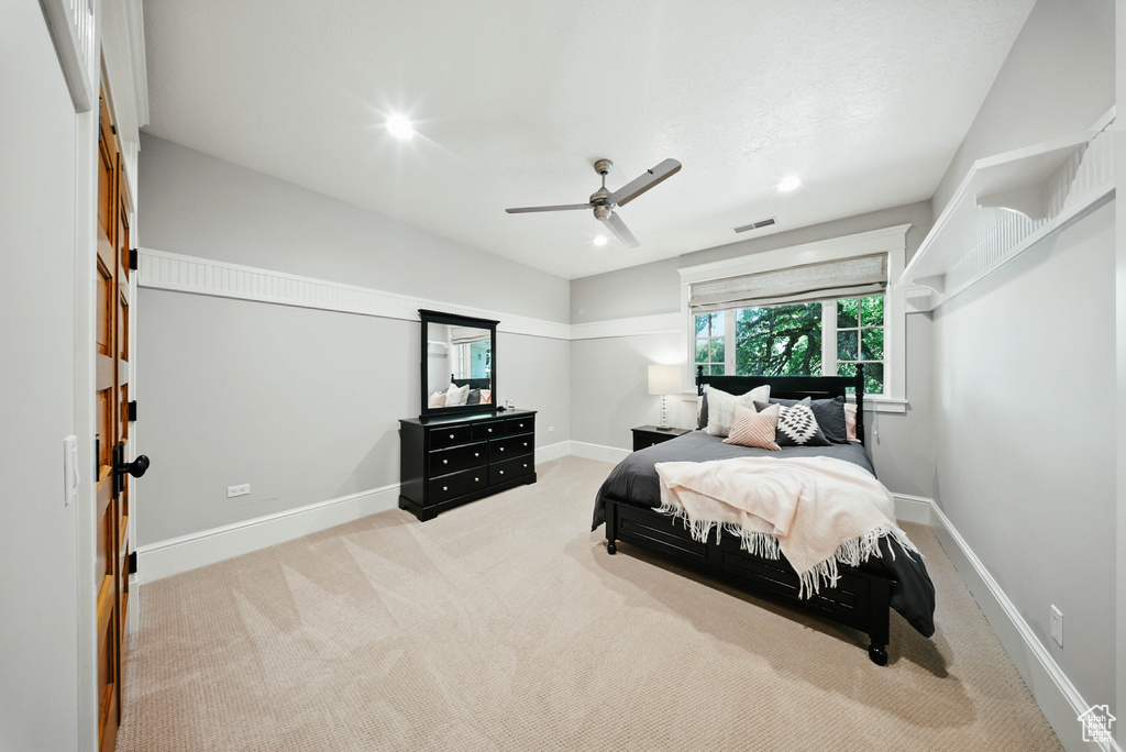 Carpeted bedroom featuring ceiling fan and recessed lighting
