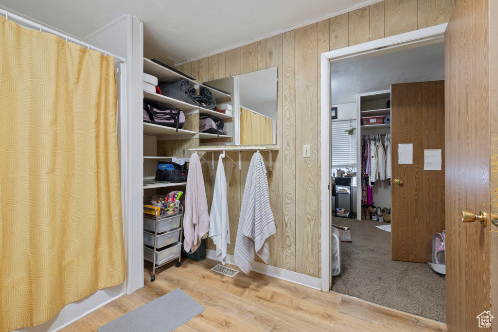 Walk in closet featuring wood finished floors