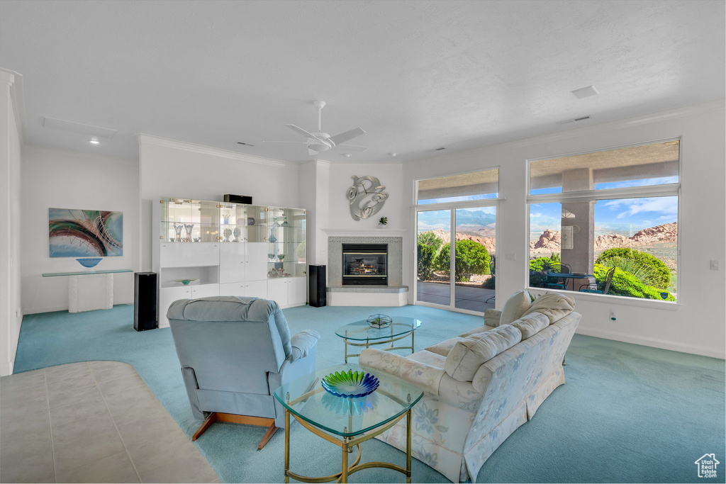 Living room featuring carpet floors, crown molding, a glass covered fireplace, ceiling fan, and recessed lighting