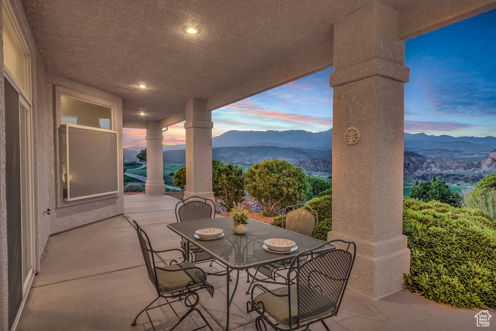 View of patio with a mountain view and outdoor dining area