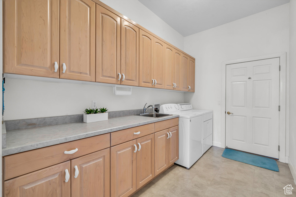 Laundry area featuring cabinet space and washing machine and dryer