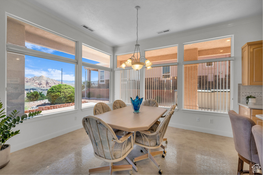 Dining room featuring a chandelier, a mountain view, and crown molding