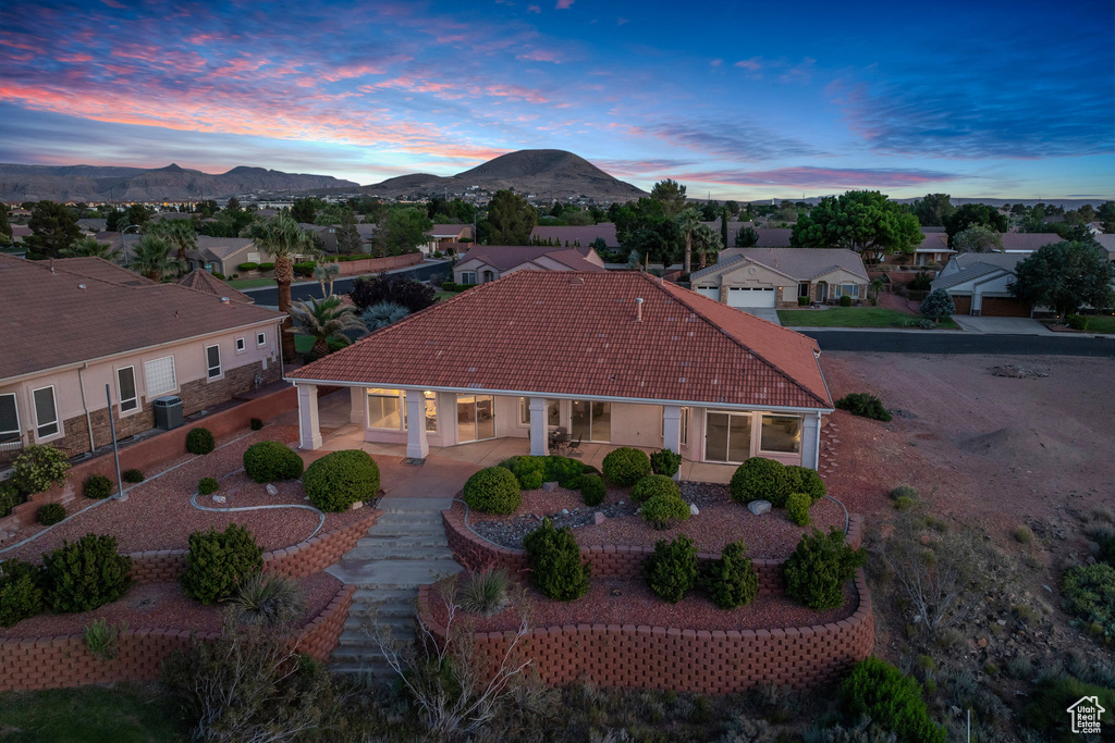 View of front of house with a tile roof, a mountain view, a porch, and a residential view