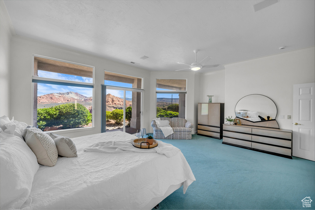 Carpeted bedroom with ornamental molding, ceiling fan, and access to exterior