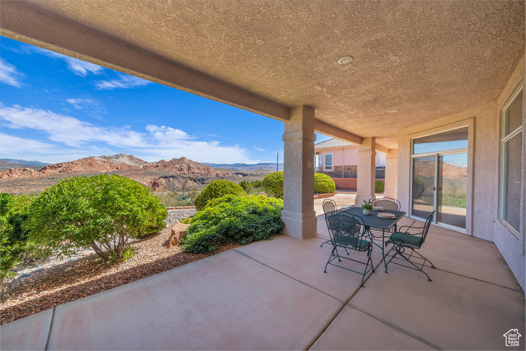 View of patio with a mountain view and outdoor dining space