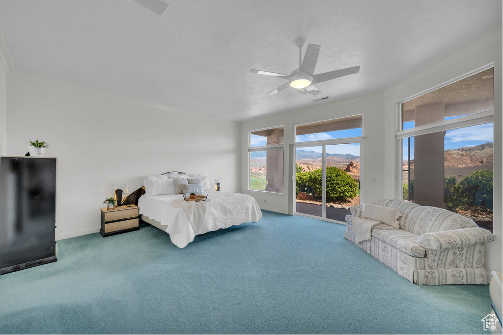 Bedroom featuring access to outside, carpet floors, ceiling fan, ornamental molding, and a mountain view