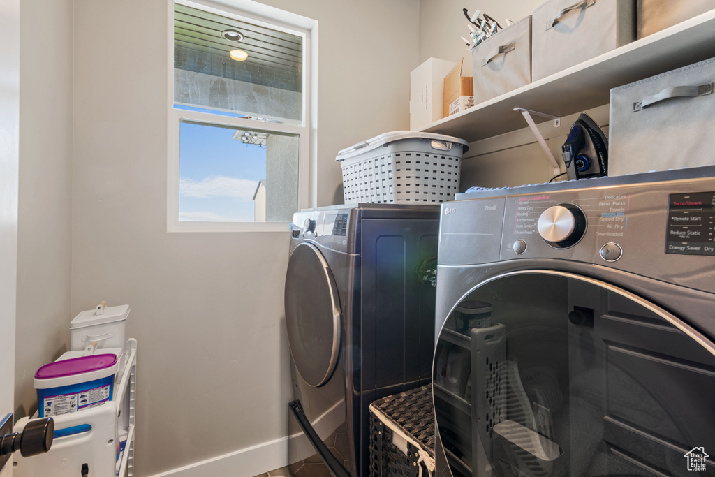 Laundry area with separate washer and dryer and baseboards