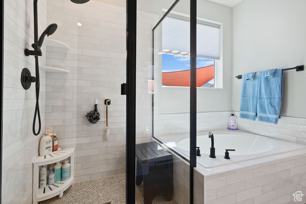 Full bath with a shower stall and a garden tub