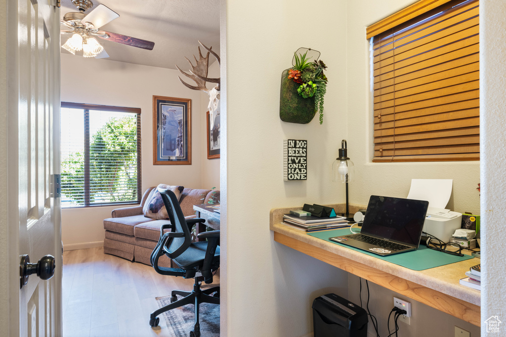 Office area with wood finished floors and a ceiling fan
