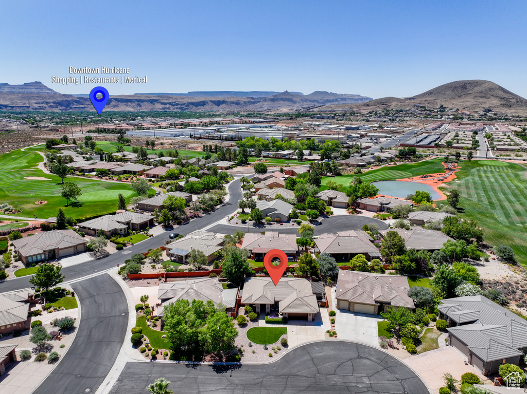 Aerial perspective of suburban area featuring a golf course and a water and mountain view