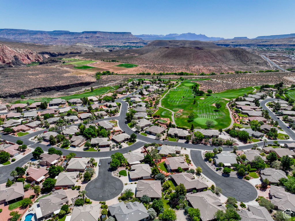 Aerial perspective of suburban area featuring mountains and a local golf course
