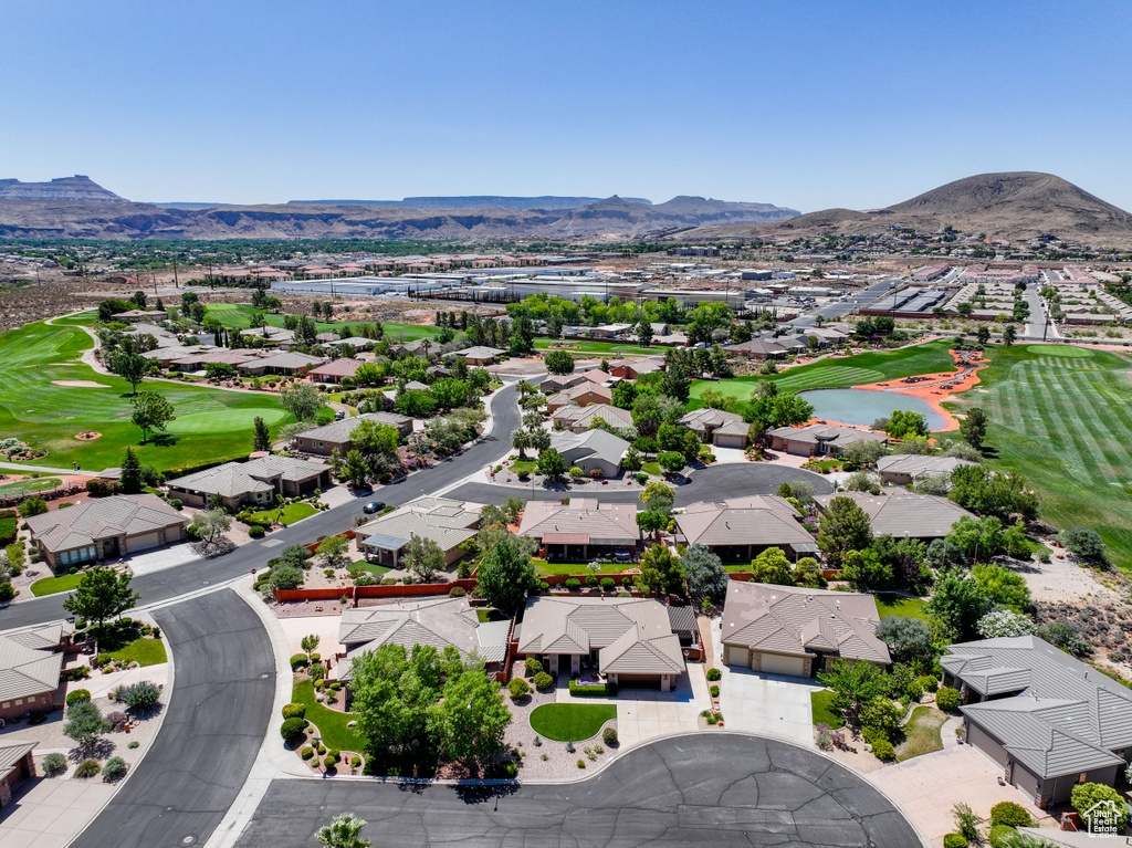 Aerial view of residential area featuring a golf course and a water and mountain view