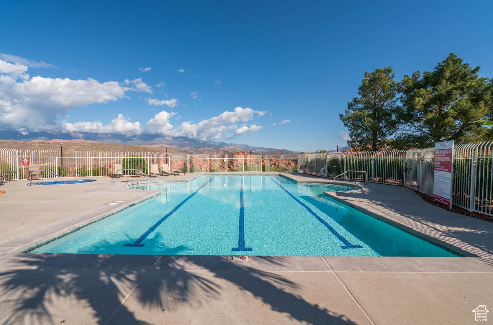 Community pool with a patio and a community hot tub