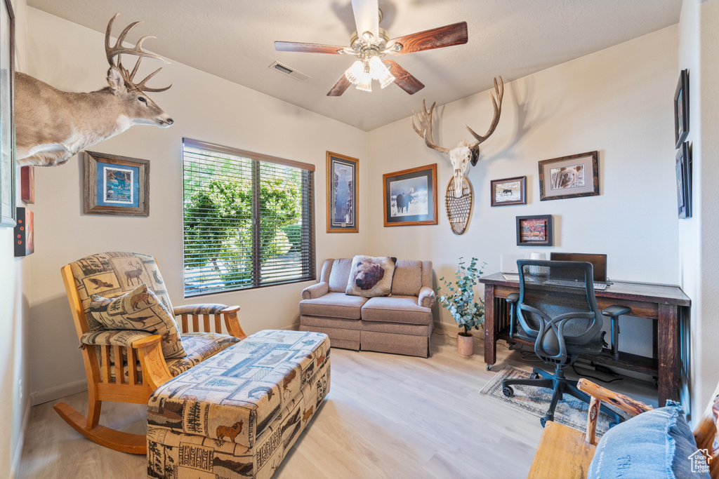 Office area featuring wood finished floors and ceiling fan