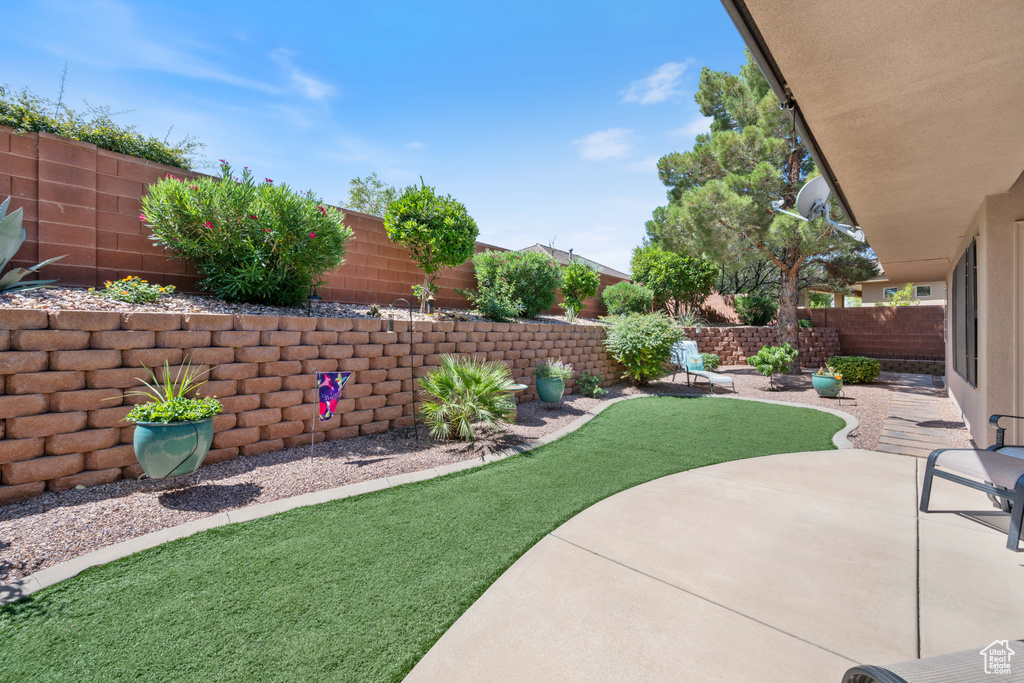 Fenced backyard with a patio