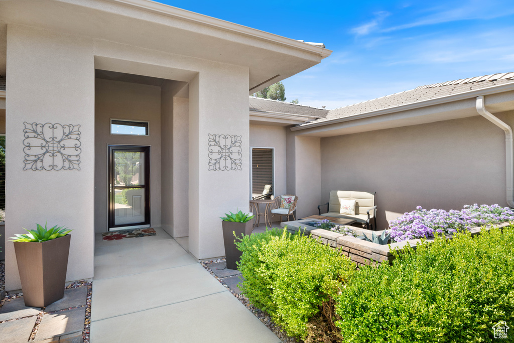 View of exterior entry featuring stucco siding