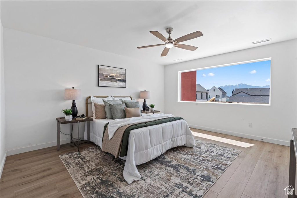 Bedroom with wood finished floors and a ceiling fan