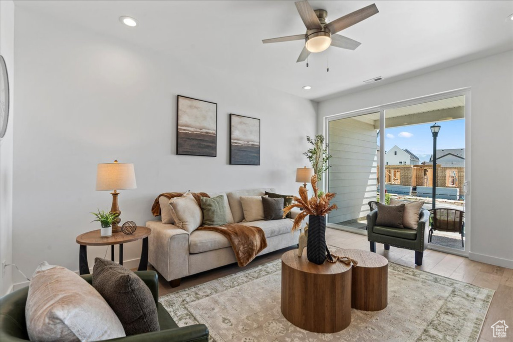 Living area featuring light wood finished floors, ceiling fan, and recessed lighting