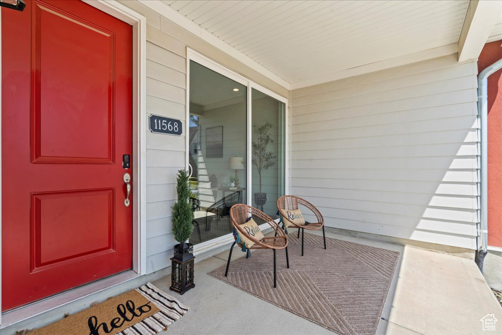 View of exterior entry featuring covered porch