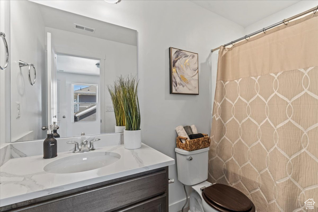 Full bathroom featuring vanity and curtained shower