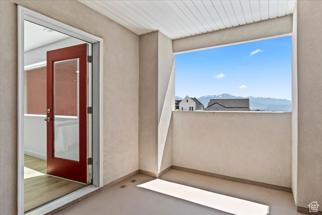 View of exterior entry featuring a mountain view and stucco siding