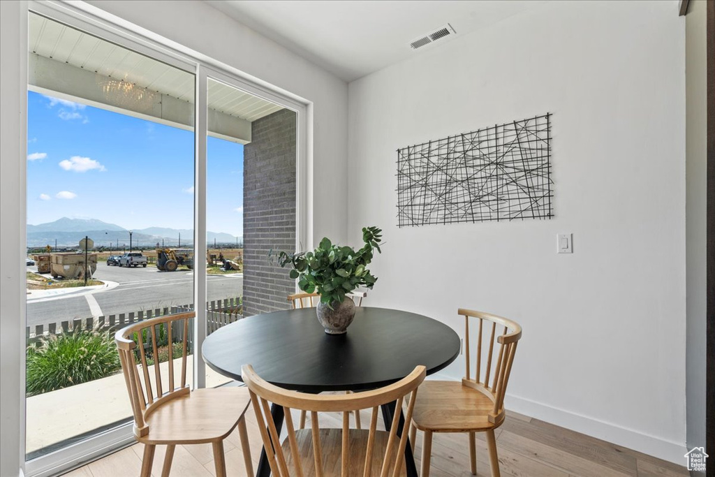 Dining room featuring a mountain view and light wood-style floors