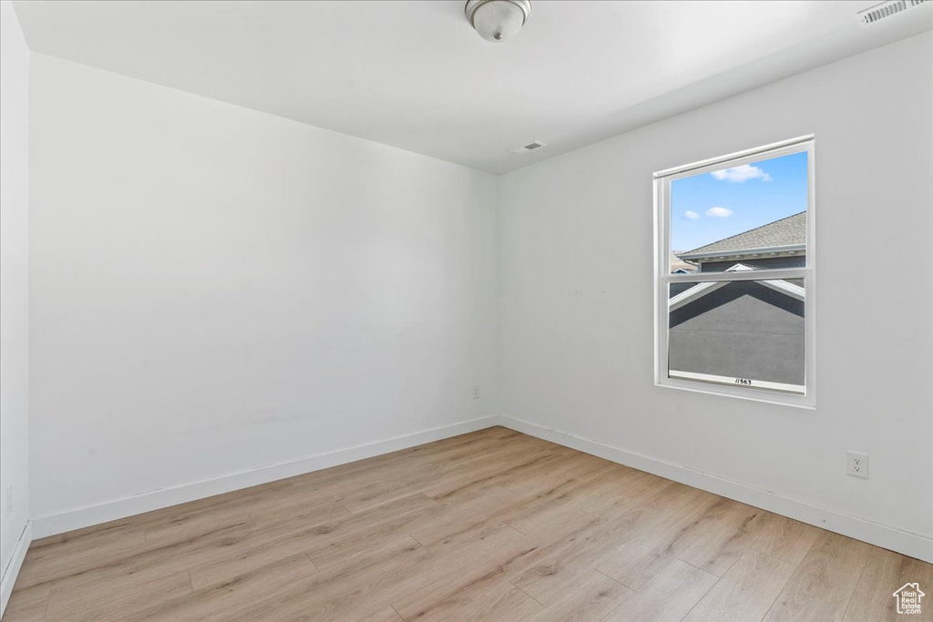 Spare room with wood finished floors and baseboards