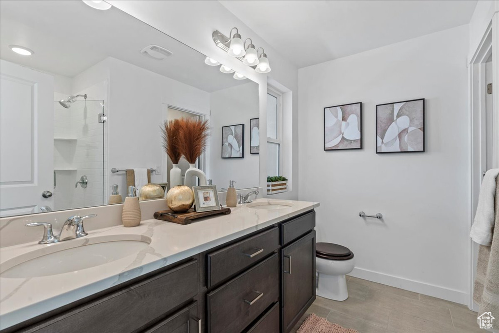 Bathroom with double vanity and a shower