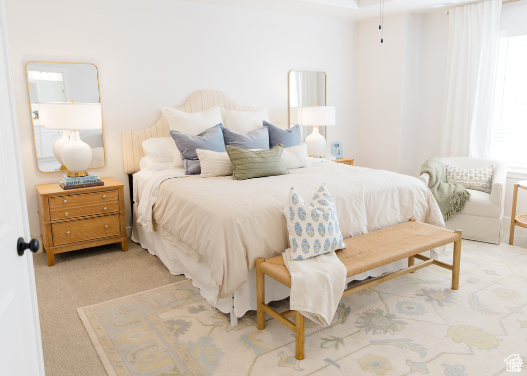 Bedroom featuring light carpet