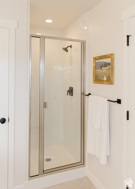 Bathroom featuring a shower stall and recessed lighting