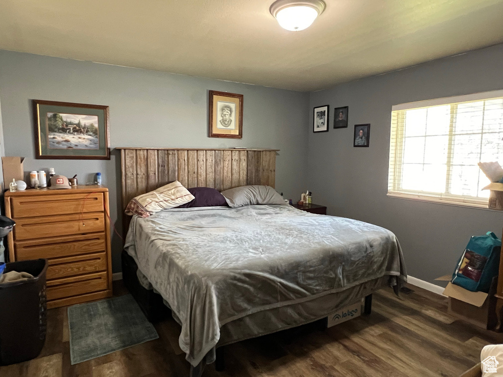 Bedroom featuring dark wood-style flooring
