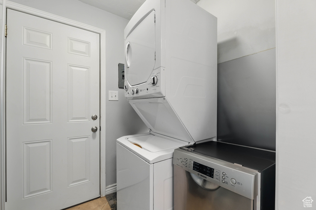 Washroom featuring stacked washer / dryer