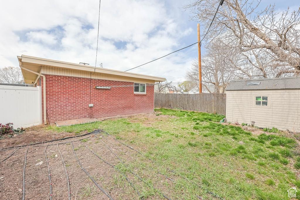 Fenced backyard with an outbuilding