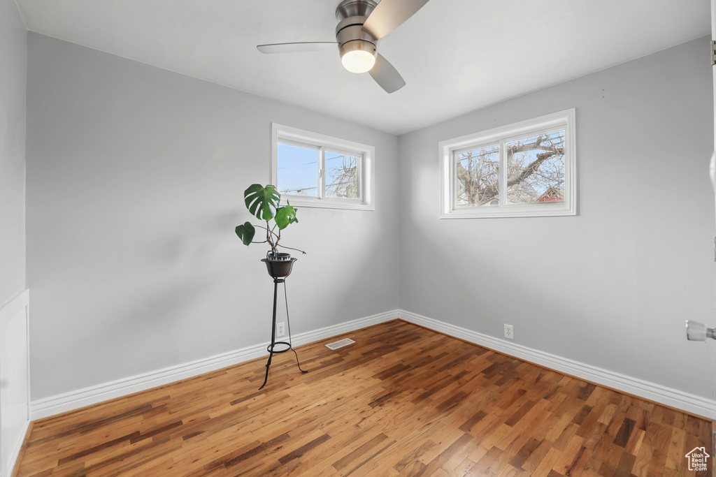 Unfurnished room featuring wood finished floors and a ceiling fan